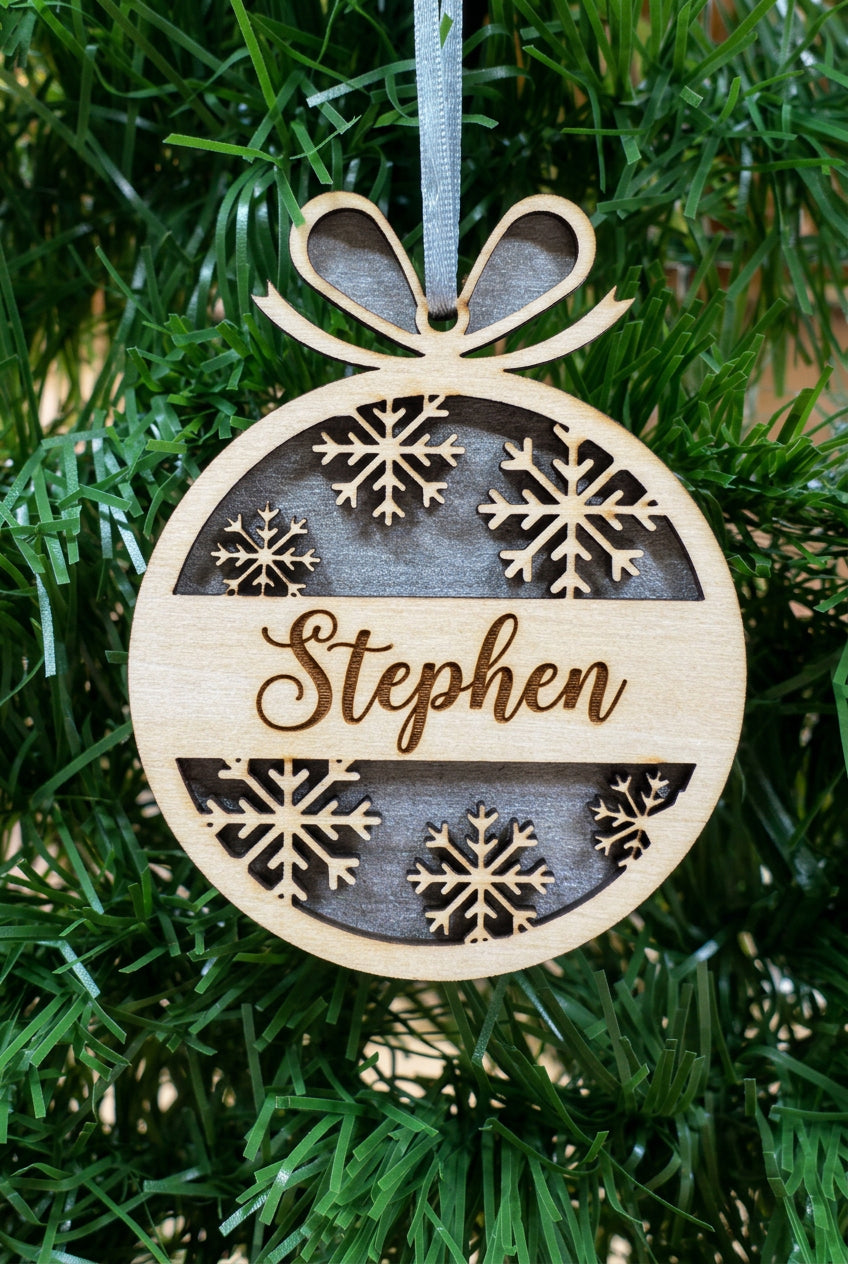 Personalised Christmas tree decoration with snowflake detail.